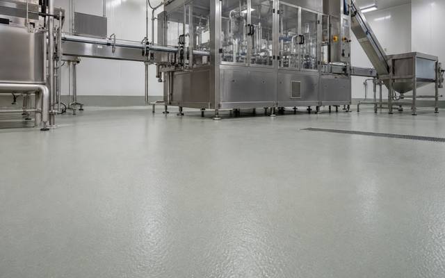 Pale green floor under a food packaging line in Lethbridge